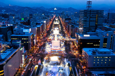 High angle view of city lit up at night