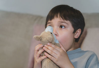 Portrait of cute boy with toy