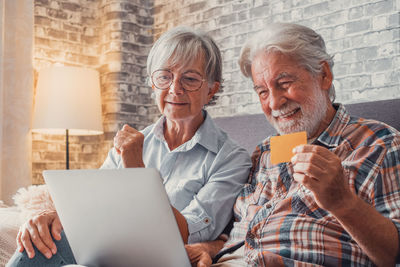 Friends using laptop at home