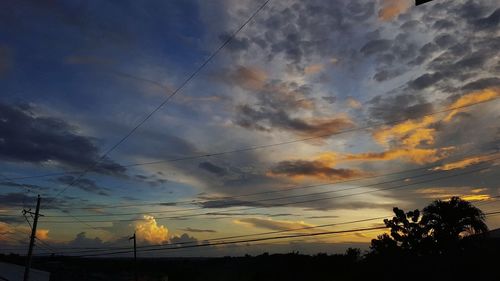 Silhouette trees against sky during sunset