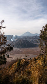 Scenic view of landscape against cloudy sky