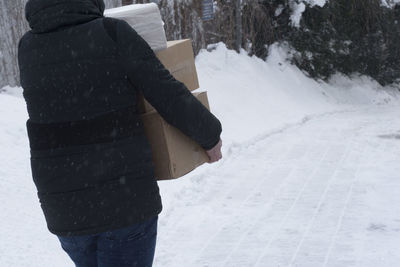 Rear view of man standing on snow