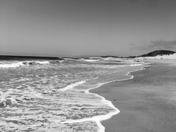 Scenic view of beach against clear sky