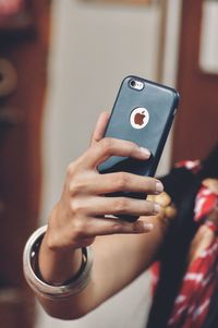 Midsection of man using mobile phone