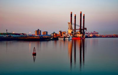 Ship in sea against sky during sunset