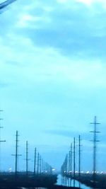 Electricity pylon against blue sky