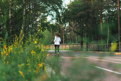 Young slim woman brunette in sport clothes running at autumn park on sunrise time