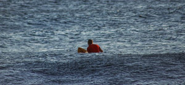 Rear view of man in sea