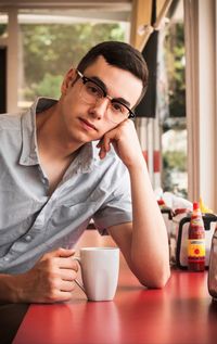 Portrait of man drinking coffee in cafe