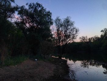 Scenic view of lake in forest against clear sky