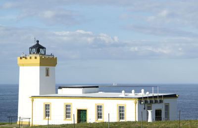 Lighthouse by sea against sky with another lighthouse in backdrop scotland nc500