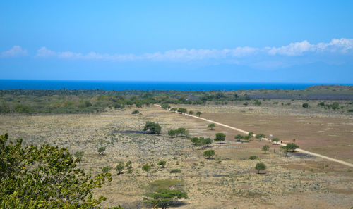 Scenic view of landscape and sea against sky