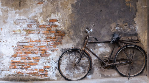 Bicycle parked against wall