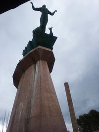 Low angle view of statue against sky