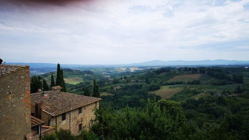 Scenic view of landscape and buildings against sky