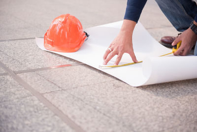 Cropped hands of man working on floor