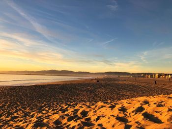 Scenic view of beach against sky during sunset