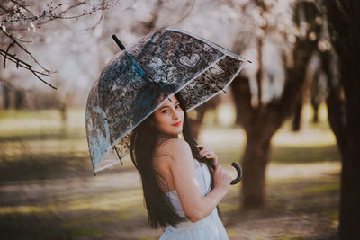 Portrait of woman wearing hat while standing on land