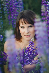 Portrait of woman with purple flower