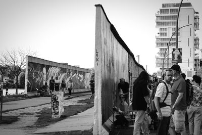 Panoramic view of people in city against clear sky