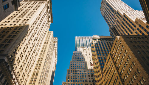 Low angle view of modern buildings against clear blue sky