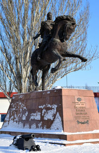 Low angle view of statue against trees