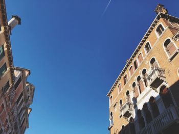 Low angle view of historic building against clear blue sky