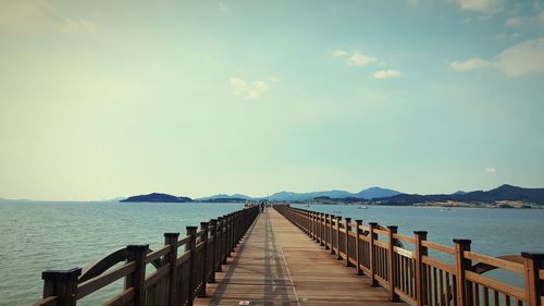 Pier over sea against sky