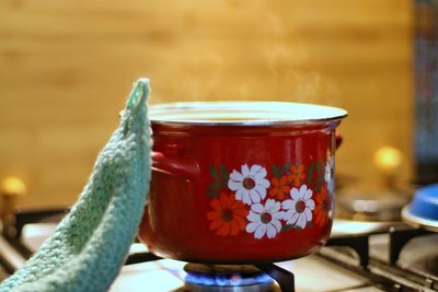 Close-up of saucepan on gas stove burner