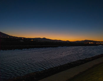 Scenic view of sea against clear sky during sunset