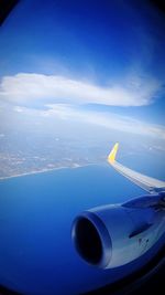 Aerial view of airplane wing against sky