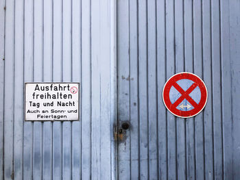 Warning sign on wooden door