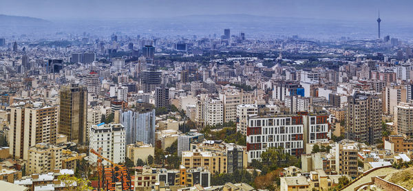 High angle view of modern buildings in city against sky