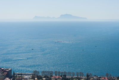 High angle view of city by sea against clear sky