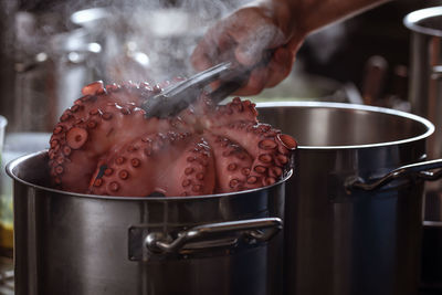 Midsection of person preparing food in kitchen