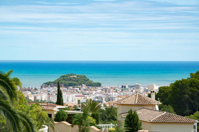 High angle view of cityscape by sea against sky