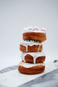 Close-up of cake on table against white background