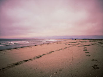 Scenic view of beach against sky during sunset