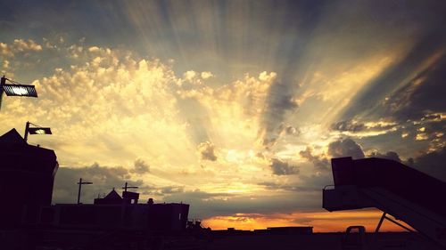 Low angle view of buildings against sky at sunset