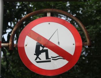 Close-up of road sign against trees