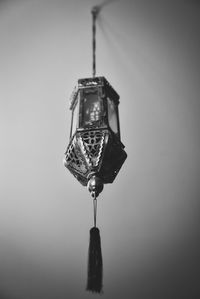 Close-up of electric lamp against wall