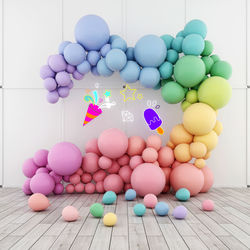 Multi colored balloons in container against wall