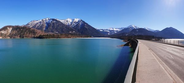 Scenic view of snowcapped mountains against blue sky