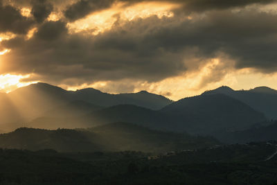 Scenic view of mountains against dramatic sky