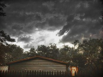 Low angle view of building against cloudy sky