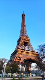 Low angle view of eiffel tower against clear blue sky