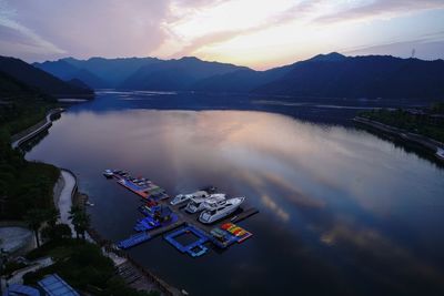 High angle view of boats moored in lake against sky during sunset