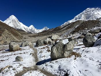 Scenic view of snowcapped mountains against clear blue sky