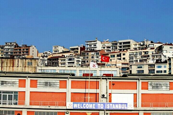 architecture, building exterior, built structure, clear sky, blue, copy space, residential structure, residential building, city, building, house, residential district, day, low angle view, red, railing, outdoors, no people, roof, cityscape