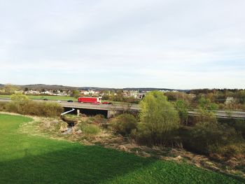 View of grassy field against cloudy sky